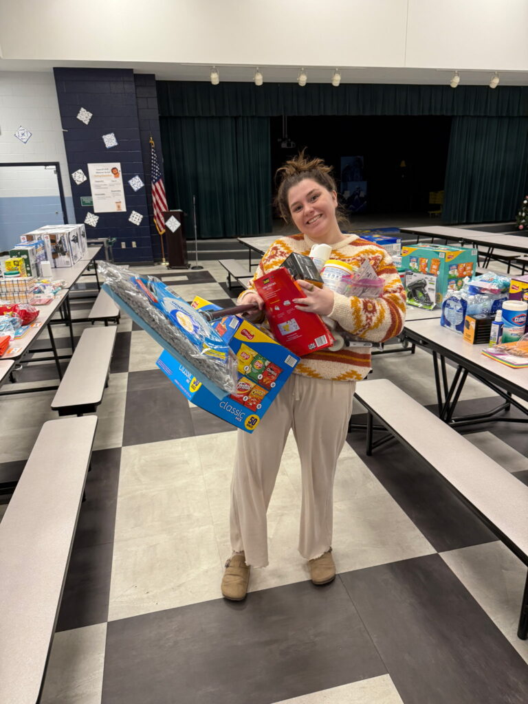 teacher holding gift in aiken